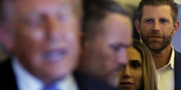 Eric Trump faded in the background behind President Trump and Melania, plus others.