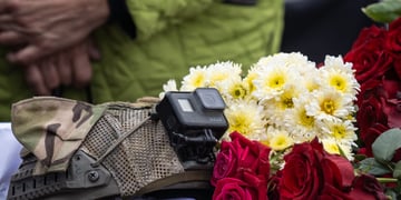 black gopro camera, white flowers, red roses, dark green and brown army uniform