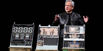 jensen huang, black leather jacket, black stage, three open pc desktop computers, grey hair