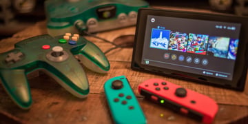 nintendo witch released in 2017, small black screen with video game on, sea blue and orange 