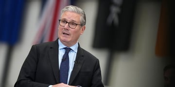 Britain's Prime Minister Keir Starmer, black suit, dark blue tie, white shirt, grey hair, glasses