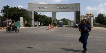 tata electronics cement gate, entrance, indian woman, blue sky, white clouds,