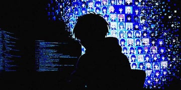 A silhouette of a hacker, hacking into an anime system.