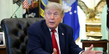 donald trump, dark suit, white collar shirt, dark red tie, usa flag pin, black leather chair