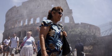 heat wave, elderly white tanned woman, rome's colosseum, sprinkles of water in the air, blue sky