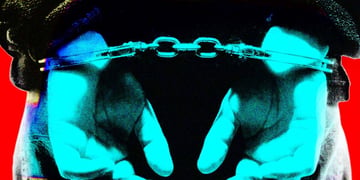 A person handcuffed behind their back