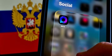 max app  icon on a smartphone, russia flag with eagles, coat of arms, in the background