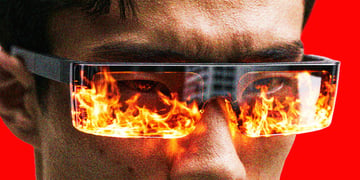 A person wearing smart glasses with flames reflecting on the lenses