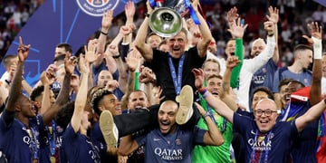 Luis Enrique sits on man's shoulder, men wearing  paris saint-germain club shirts, hands up