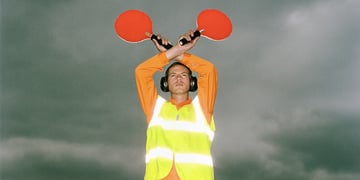 An air traffic controller holding light signals up in the air