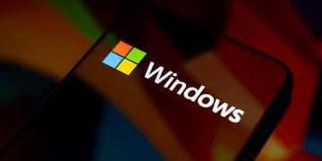 The Windows logo appears on the screen of a smartphone