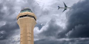 FAA air control tower and plae in background