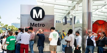 People standing next to LA Metro