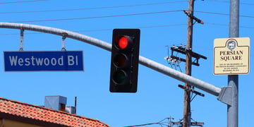Persian Square and Westwood signs hanging from street light
