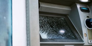 Broken glass ATM on street