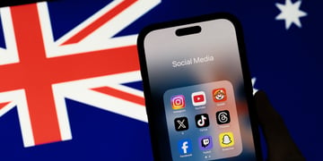 Logos of various social media apps on a phone screen next to Australian flag.