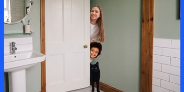 cat and kids trying to get into through closed bathroom doors