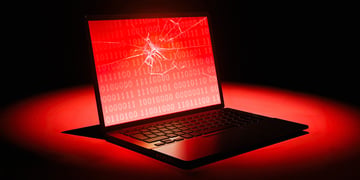 laptop with a broken glass, red, black background