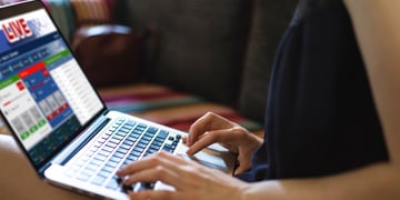A woman is placing a bet on a gambling website.