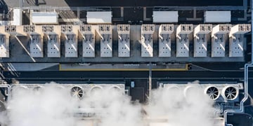 Aerial drone view of a large hyperscale data center cooling system with massive industrial fans