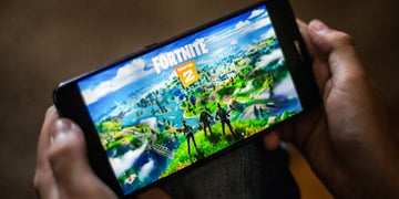 Device with Fortnite logo held with two hands