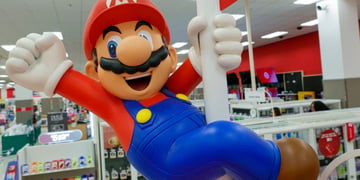 super mario on white poll, blue pants, red top, white man, brown moustache, red hat, big nose