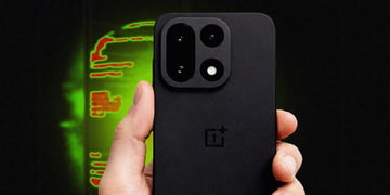 OnePlus 15 smartphone held in hand with a black and green backdrop.