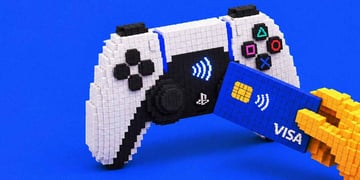 A hand making a card payment via PlayStation controller