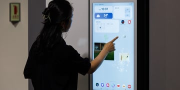 Woman using Samsung smart fridge
