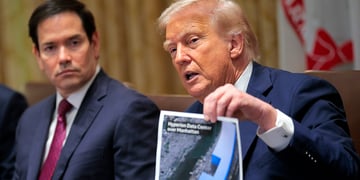 Donald Trump holds up a picture of a data center
