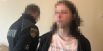 blurry male face, shoulder length hair, police officer in dark blue uniform, white t-shirt