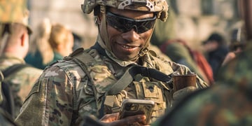 An American soldier holding a smartphone.