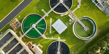 Water utility plants pictured from above, surrounded by greengrass