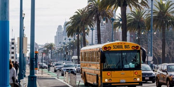 San Diego school bus on city streets with palm trees