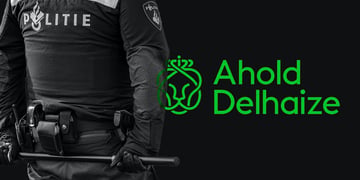 Ahold Delhaize and Dutch police officer holding a baton behind his back