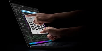 Hand using Apple MacBook Pro touchscreen