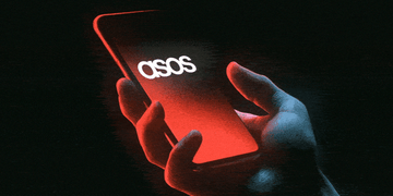 Smartphone displaying ASOS hack notification.