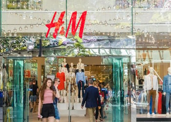 Young woman walking out of H&M store in Brisbane stock photo-3
