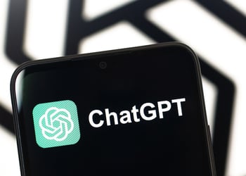 The ChatGPT logo is seen displayed on a smartphone screen.