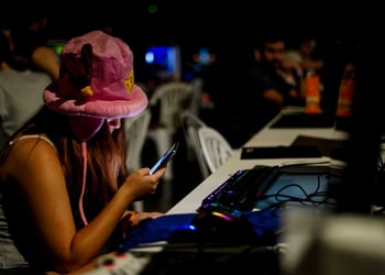tenage girl, fluffy pink had, smartphone, computers, dark, tanned white skin, dark room