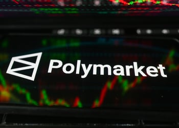 polymarket logo, white letters on black smartphone screen, market percentage charts in the back