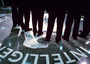 Footsteps and shadows on the CIA logo.