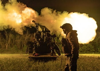 ukrianian soldier in uniform, helmet, white male, night time field, explosion artilery