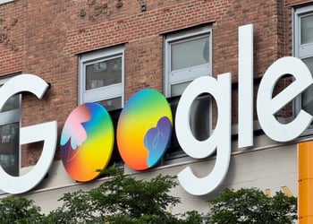 google logo, two colorful globes instead of two o's, yellow traffic light, brick building