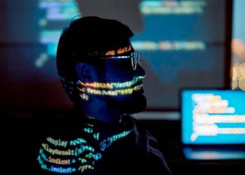 man with beard and moustache, profile, glowing code all over his face and shoulder line