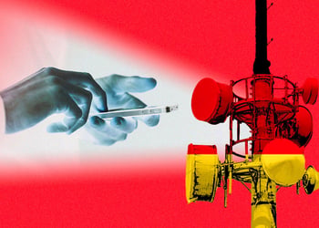 Hands holding a smartphone, German flag, a cell site