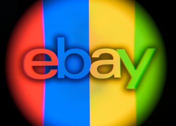 ebay logo in round shape that's in red, blue, yellow, green stripes, black background