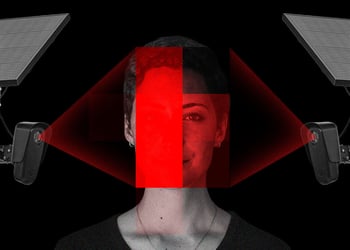 A woman's face lit up by two surveillance cameras