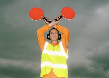 An air traffic controller holding light signals up in the air