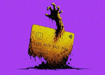 An expired credit card with a zombie-like hand reaching through it
